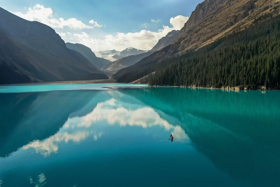 Sky reflecting in glacial lake. Drone shot by Alex Taylor | Losing Blue