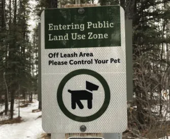 Sign reading "Entering Public Land Use Zone - Off Leash Area - Please Control Your Pet"